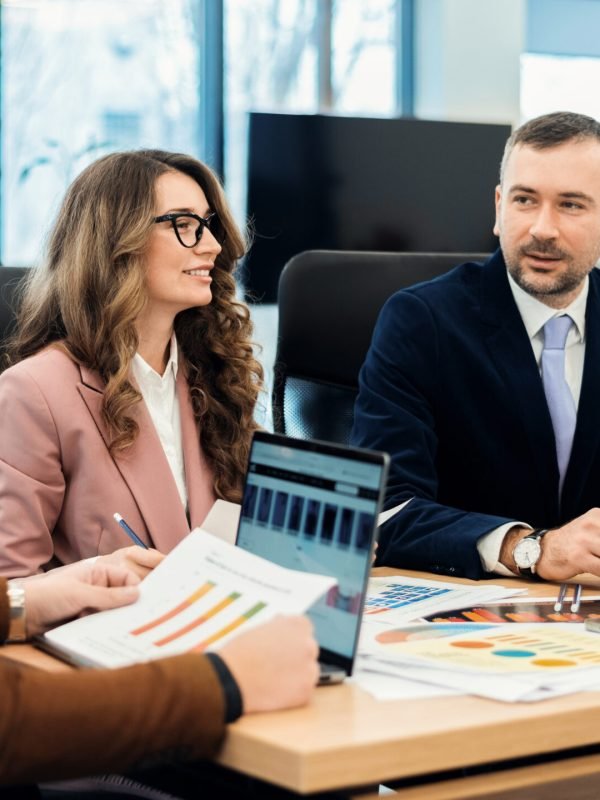 Business meeting in an office, workers discussing business affairs. Gadgets and papers on the table