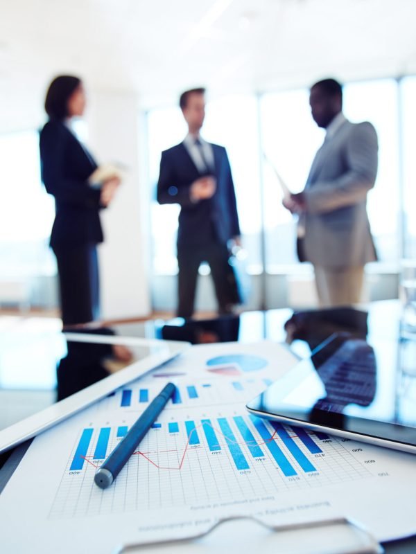 Paper with business data and touchpads on workplace